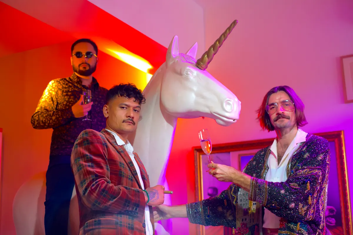 The LIVEUPTOYOURWORD crew in their finest, toasting beside a unicorn